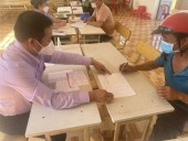 Cán bộ Ngân hàng Chính sách xã hội huyện đang đối chiếu số tiền vay với khách hàng tại xã Đăng Hà