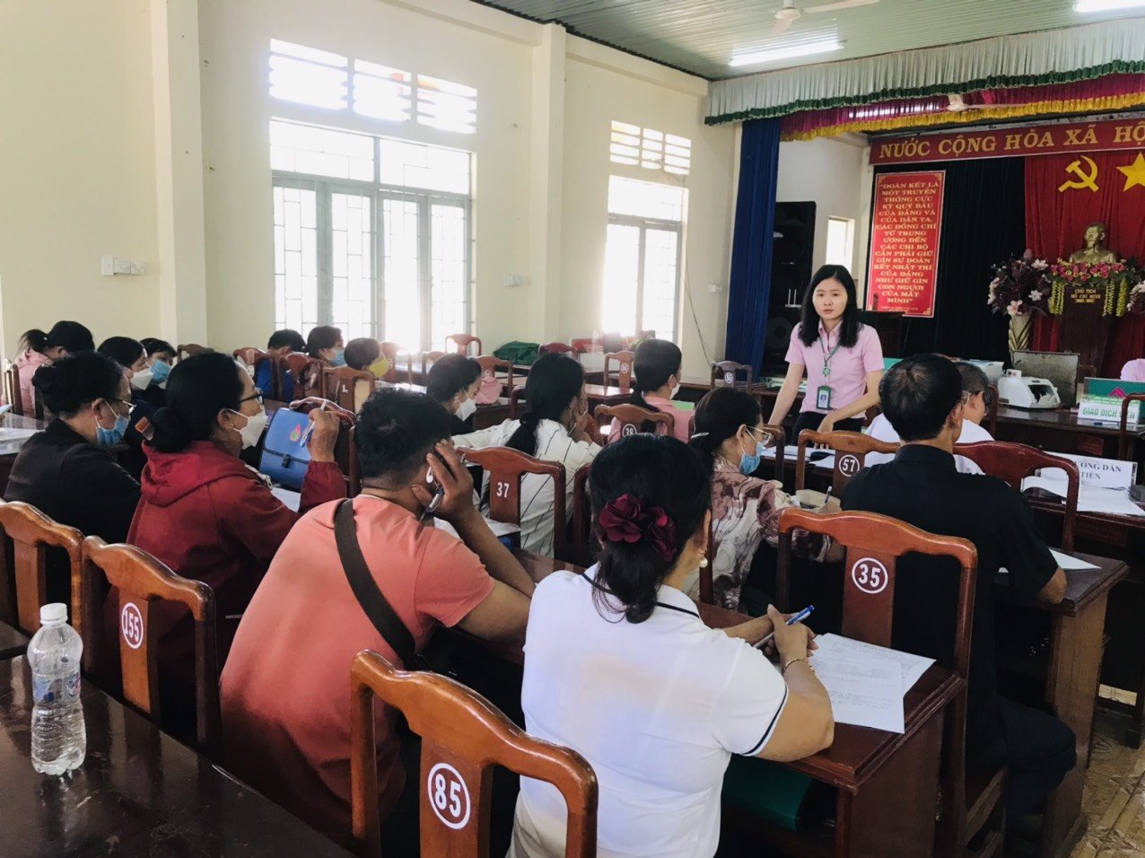 Cán bộ Ngân hàng Chính sách xã hội huyện tuyên truyền về hỗ trợ lãi suất đến với người dân tại Điểm giao dịch xã